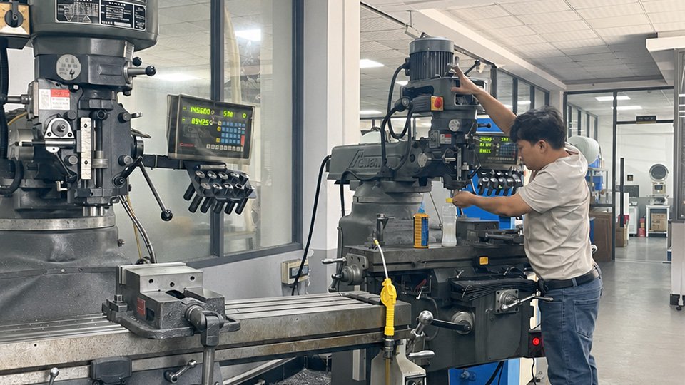 Operator operates milling machine in CNC precision machining workshop